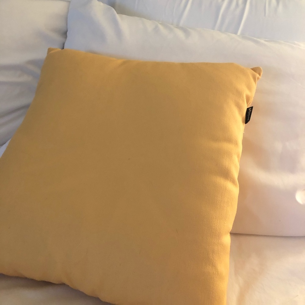 Yellow throw pillow with removable cover